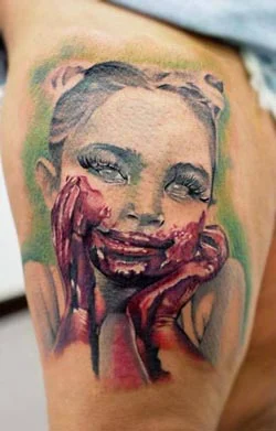 Dark portrait tattoo with red and black detail